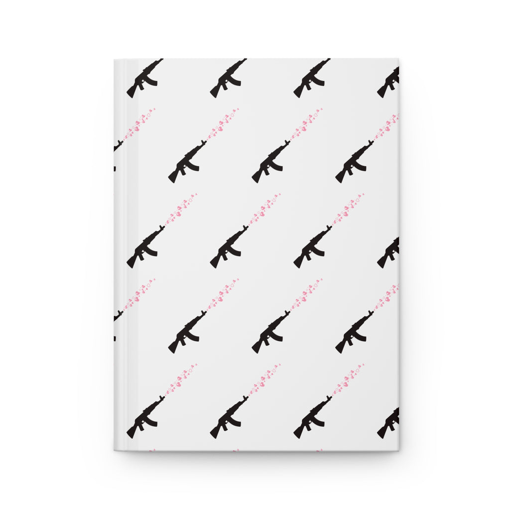 A hardcover notebook with a white cover featuring a repeating pattern of black rifle silhouettes and pink hearts