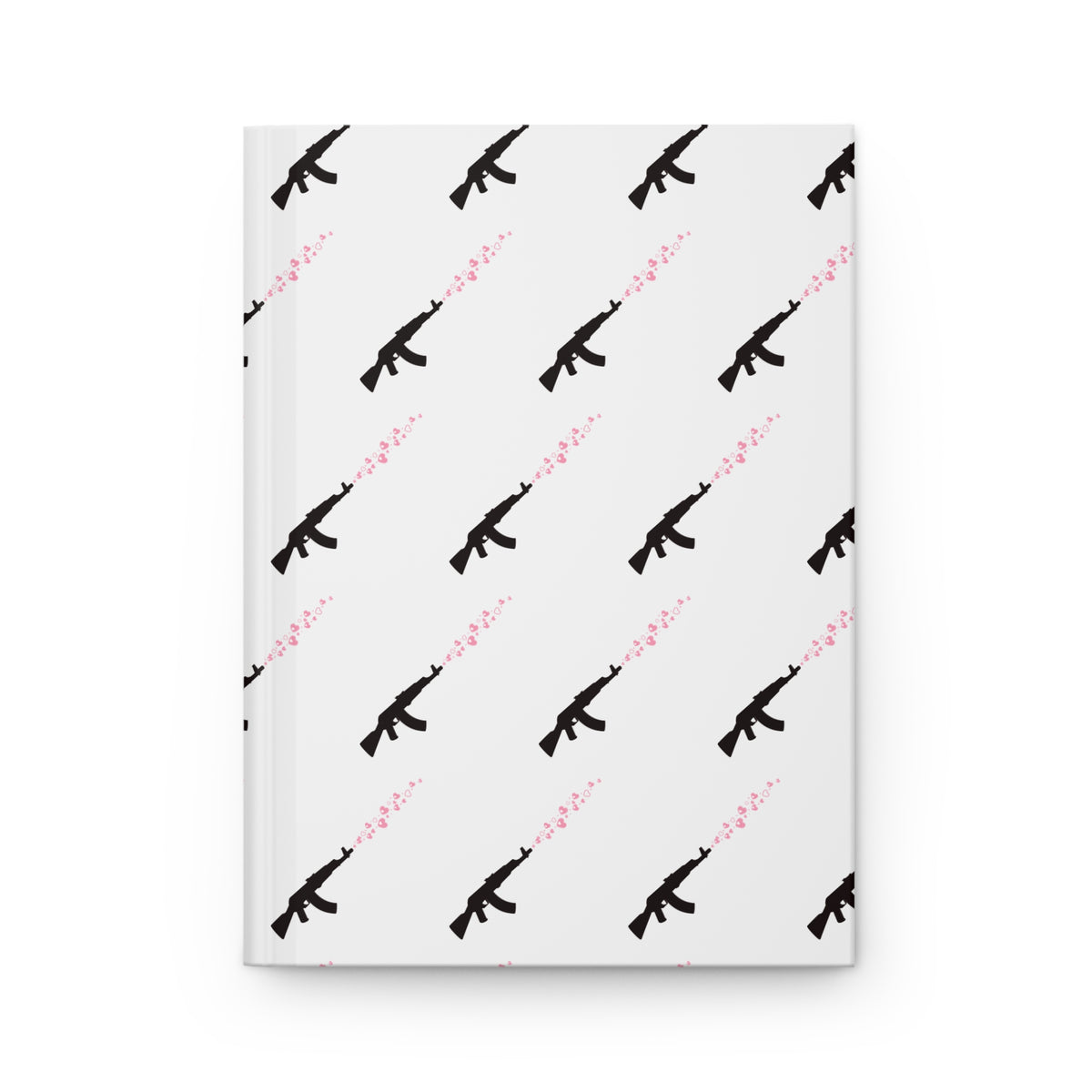 A hardcover notebook with a white cover featuring a repeating pattern of black rifle silhouettes and pink hearts
